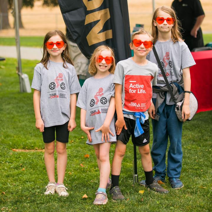 Smiling kids with heart shaped sunglasses at diabetes camp