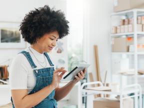 black-woman-online-shopping-and-tablet-at-warehouse