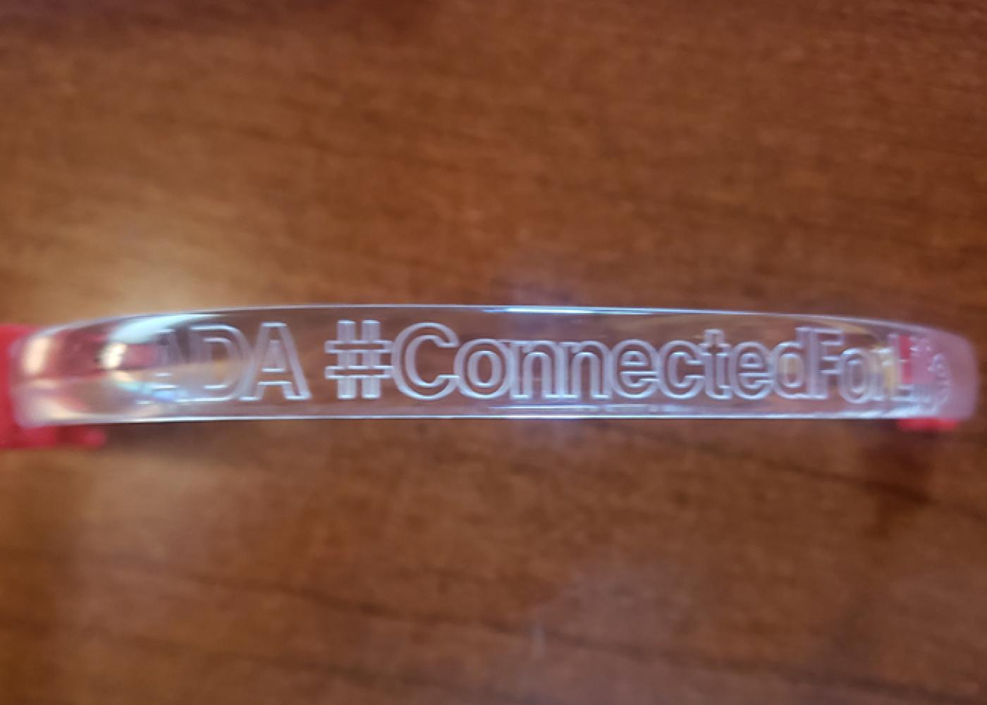 Close-up of ADA#Connected acrylic wrist band