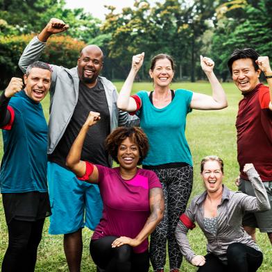 Smiling group of enthusiastic exercisers outside