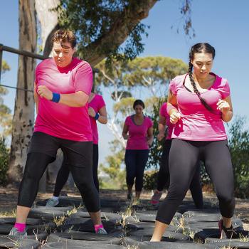 women-pink-shirts-exercise-obstacle-course-tires